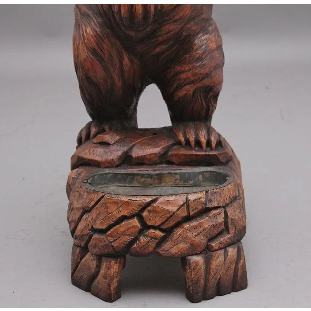 19th Century black forest bear stick/umbrella stand constructed in linden wood, the stand consisting of a bear standing on...
