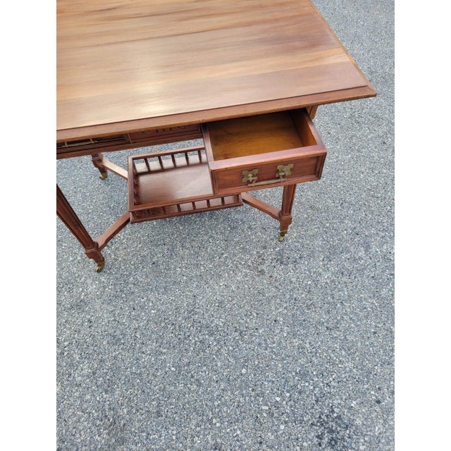 This 19th century French solid cherry partner desk is a beautiful antique piece with a rich brown color and antique brass...