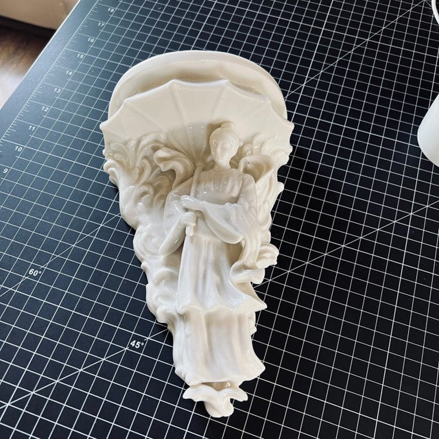 Vintage Italian porcelain wall shelf looks like an angel. do not have any real information on this classic item other than...