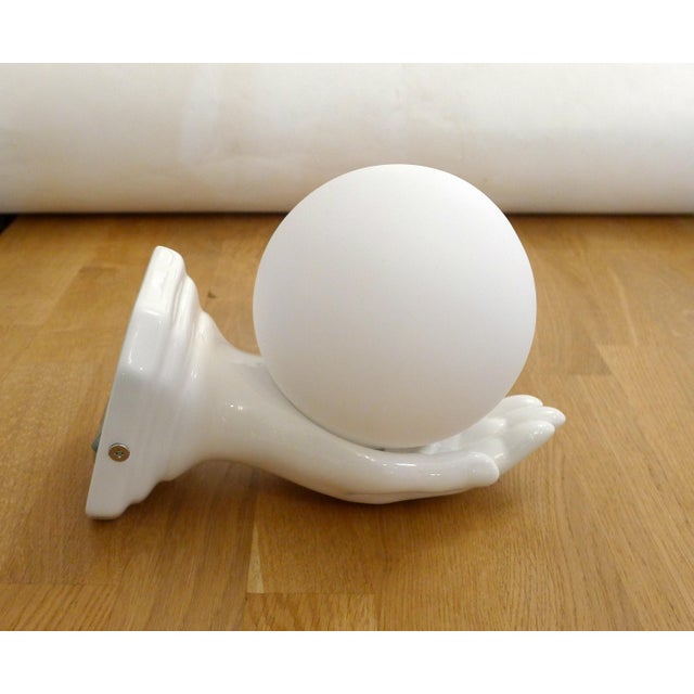 Hand wall sconce: beautiful square stepped base, Art Deco style, and an outstretched hand with an open palm holding a...