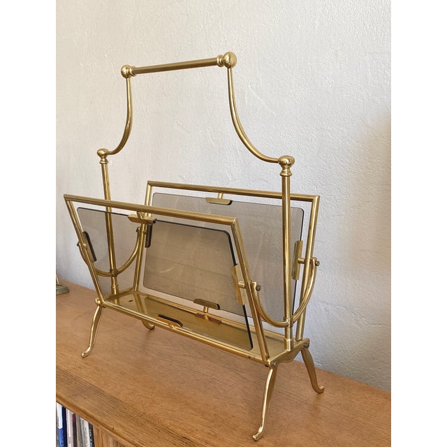 Impressive Italian magazine/newspaper rack in gilt brass and smoked glass Produced in the 1950s Designer: Cesare Lacca...