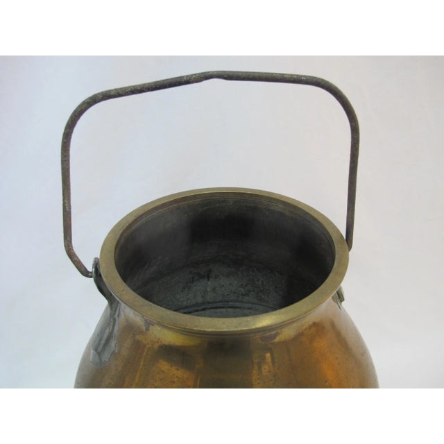 19th century copper milk pail with handle. Measures 14" tall x 11" wide at base x 7" wide opening.