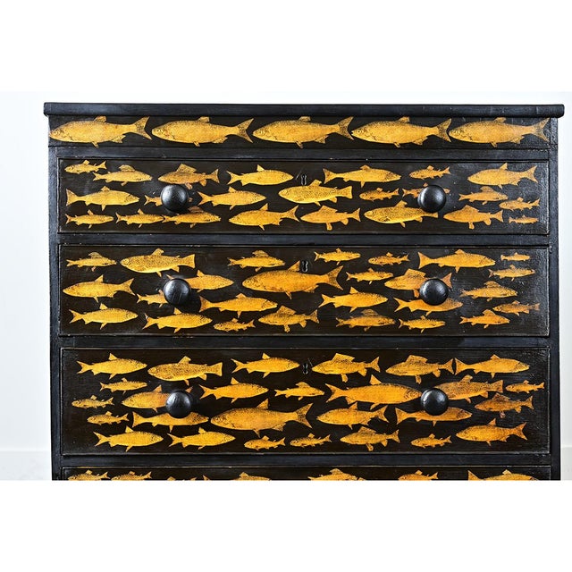 A vintage English chest of drawers recently updated with new paint of ebonized effect and pasted decoupage fish. The...