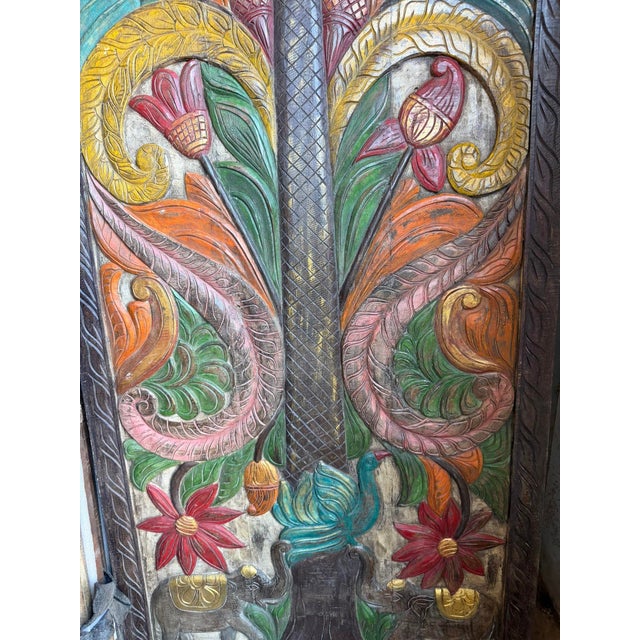 Add a touch of global artistry and timeless craftsmanship to your space with this exquisite hand-painted carved wood door...