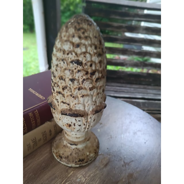 Striking antique cast iron pine cone finial with beautifully preserved layers of original white paint, rich oxidation, and...