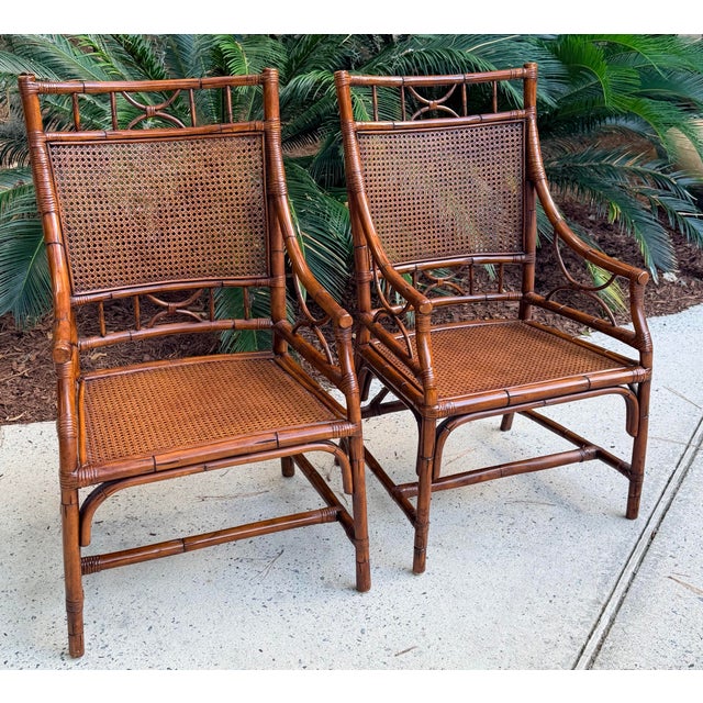 Vintage pair of classic bamboo armchairs. Handcrafted with cane seats and bamboo frames. Chinoiserie inspired. These are...