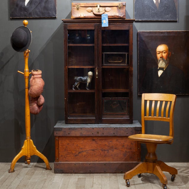 ABOUT An antique Mahogany glass door cabinet with four shelves and bronze handle. Solid Mahogany throughout. Graduated...