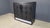 Black ebonized wood bar cabinet with graphical brutalist design doors and a marble inlay at the base INtegrated drawers...