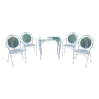 Wrought Iron Patio Set—Four Armchairs and a Table With a Glass Top For Sale