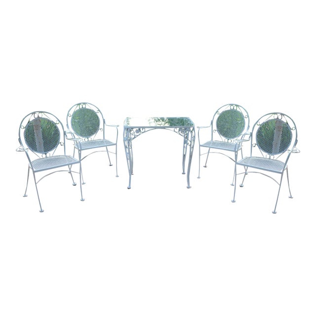 Wrought Iron Patio Set—Four Armchairs and a Table With a Glass Top For Sale