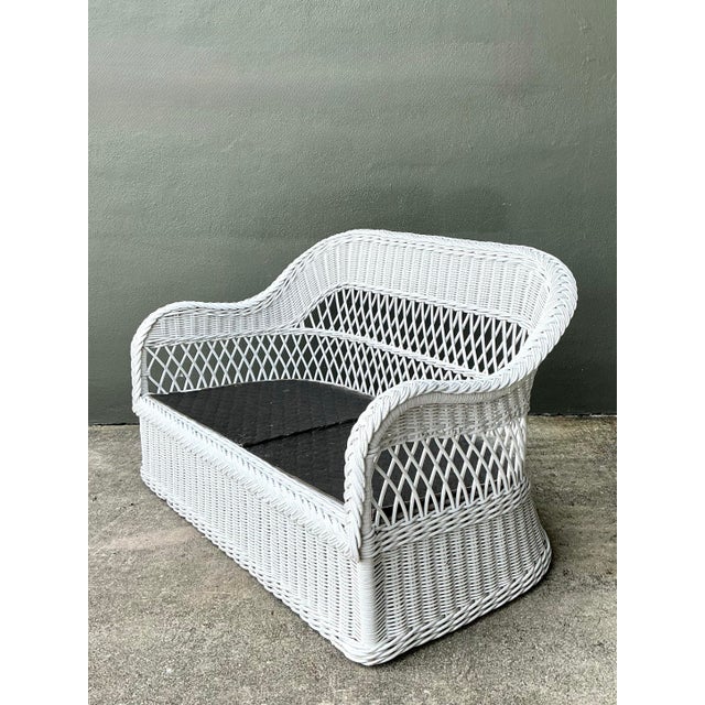 Vintage Lexington braided white rattan love seat with a gracefully contoured back and armrests, showcasing a skillful...