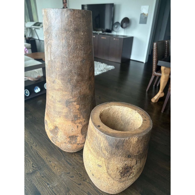 A striking pair of large hand‑carved wooden vessels showcasing the raw beauty of organic modern design. Each piece is...