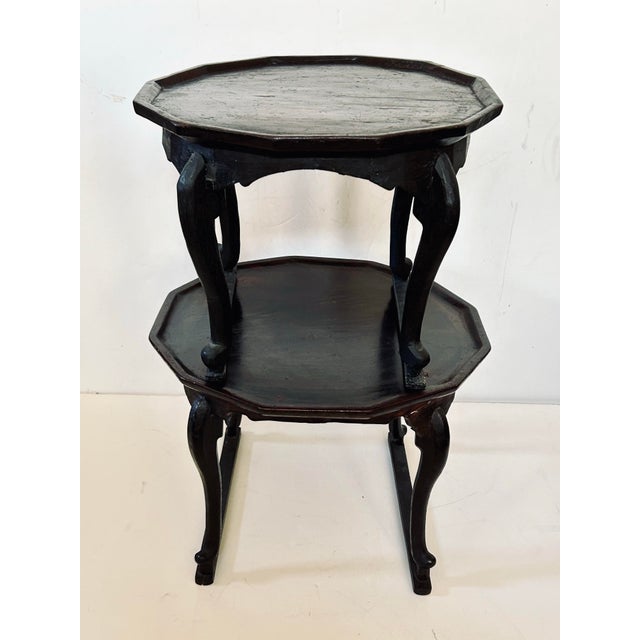 This pair of antique Japanese serving tables have a lovely patina and gracefully curved cabriole legs braced on both...