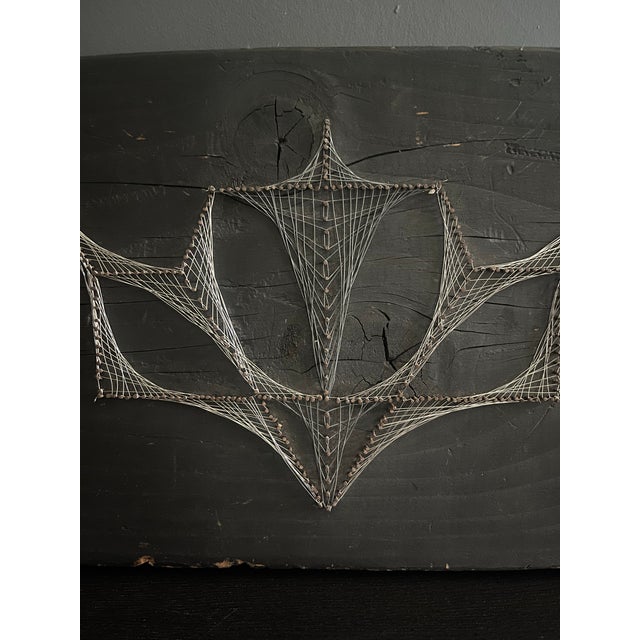A striking example of mid-1970s American string art, this sculptural wall piece features a hand-woven crown motif rendered...