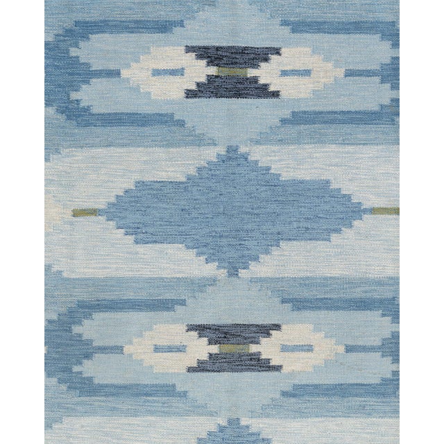 A delightful mid-century circa 1960 Scandinavian hand knotted rug with wonderful colors woven into the design.