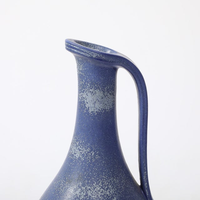 This well balanced and beautifully colored Mid-Century Modernist Cobalt Blue Glazed Ceramic Pitcher by Gunnar Nylund for...