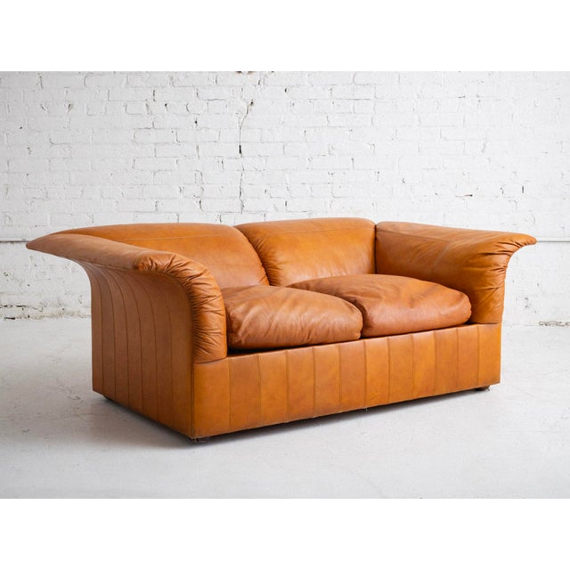 Mid-century two-seater sofa by Luigi Massoni for Poltrona Frau, distinguished by flared arm and backrests. In original...