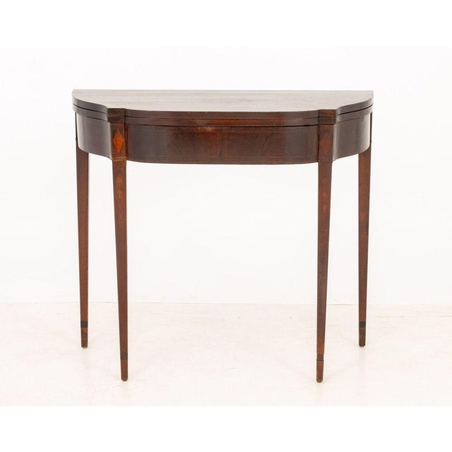 American Federal Inlaid Mahogany Card Table, the flip-top above tapered legs. 30" H x 34" W x 17.25" D. Provenance: The...