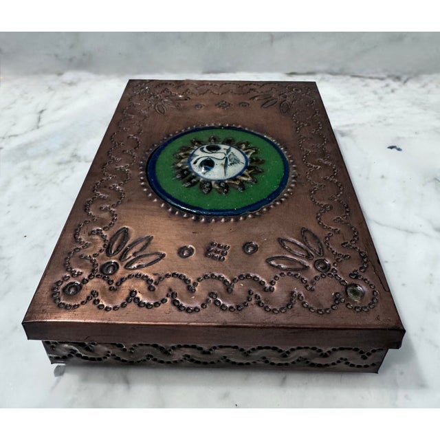 Copper metal box with relief of enamel sun lion on the lid. A cute addition to a coffee table or bookshelf!