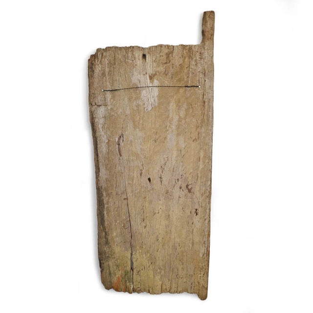 Old hand-carved Igbo grain door from southeastern Nigeria featuring deeply incised geometric motifs and an aged...
