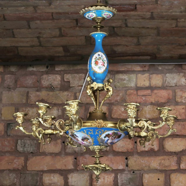 Chandelier for 15 candles, made in Louis XVI style, decorated with embossed gilded decor in the form of foliage and...