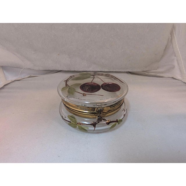 This vintage late nineteenth century continental victorian trinket box is designed in clear glass with enamel decorations....