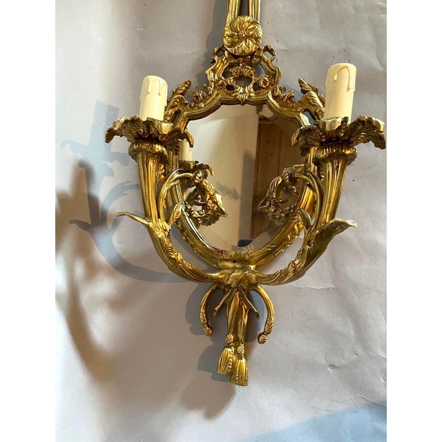 This elegant pair of late 20th-century French wall sconces reflects the balanced proportions and classical ornamentation...