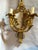 This elegant pair of late 20th-century French wall sconces reflects the balanced proportions and classical ornamentation...