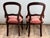 This lovely pair of Victorian walnut balloon back side chairs dates to the late 19th century and captures the refined...