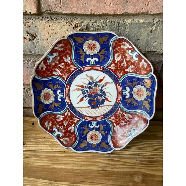 An elegant Japanese Imari porcelain charger plate dating to the Mid 20th Century. Markings on the back. This gorgeous hand...