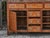 An English oak buffet from the 19th century with six drawers, two doors and brass hardware. This 19th-century English oak...