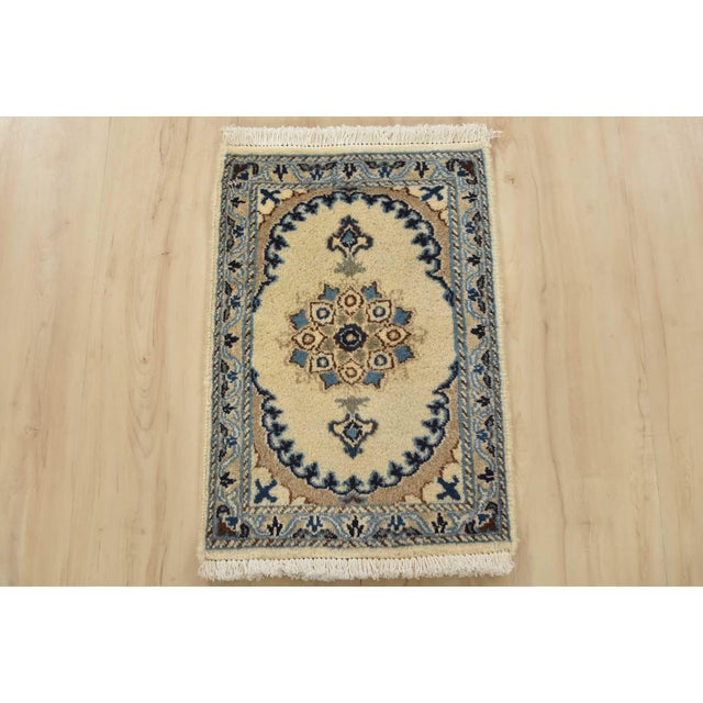 An authentic vintage traditional Nain rug hand-knotted with fine wool and natural dyes. This oriental rug features a...