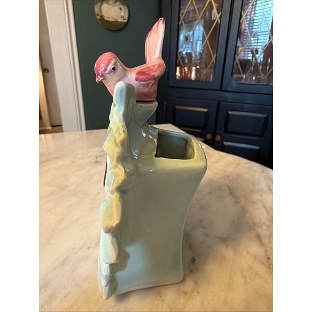 This Vintage McCoy Pottery Wall Pocket features a charming design of a pink bird perched on a blue flower. Made in America...