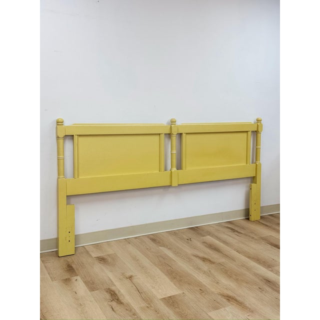 This vintage king headboard brings a cheerful cottagecore sensibility to any bedroom, finished in a soft yellow tone that...