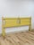 This vintage king headboard brings a cheerful cottagecore sensibility to any bedroom, finished in a soft yellow tone that...