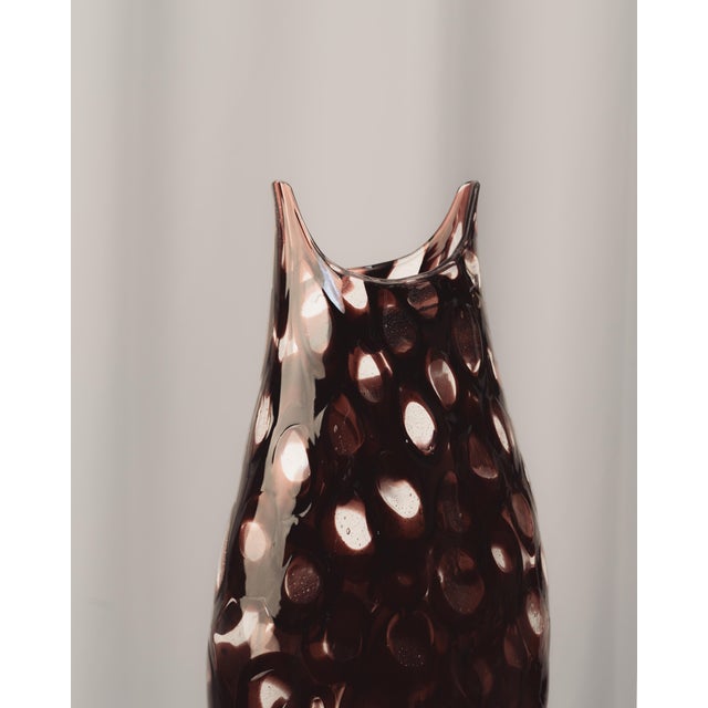 Murano glass vase manufactured by Paolo Crepax. Ovoid body of blown glass with transparent and garnet color, featuring...