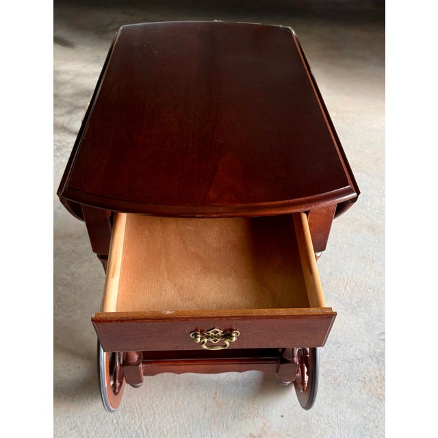 This vintage Tea Trolley’s construction showcases elegant craftsmanship with beautifully turned wooden posts and a spindle...