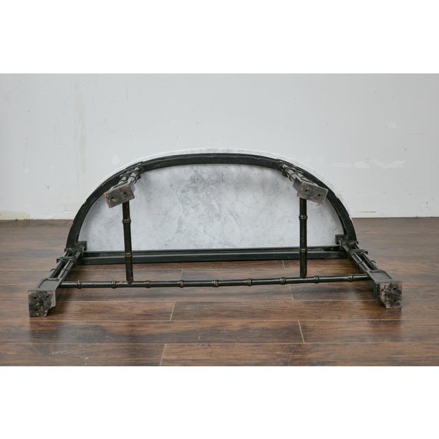 An English Midcentury demi-lune console table with ebonized faux-bamboo base and white veined marble top. This English...