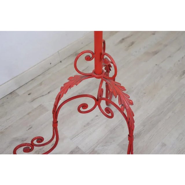 Fantastic Italian vintage clothes hangers in red lacquered iron. Beautiful ironwork with scrolls and curls. Good general...