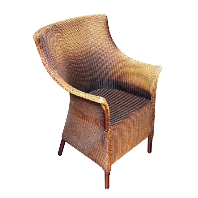 A Lloyd Loom lounge or deck chair, synonymous with Classic English style, featuring a flowing, squared back of painted...