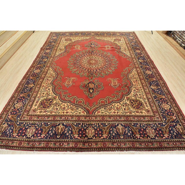 An authentic vintage traditional Tabriz rug hand-knotted with fine wool and natural dyes. This oriental rug features a...