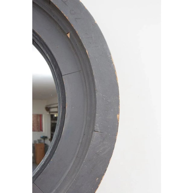 This unique wall mirror is made from a matt grey painted wooden industrial mold that has been inset with a convex mirror....