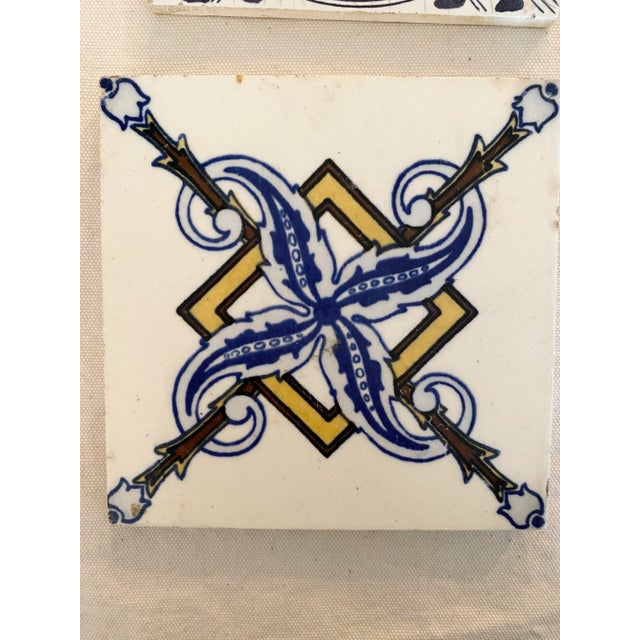Lot of 4 different styles of Antique tiles. The pinwheel design is from Villeroy and Bosh Mettlach. The other 3 are unmarked.