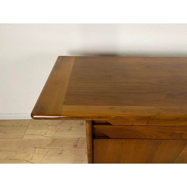 Walnut sideboard with four drawers and two doors, designed by Titina Ammannati and Giampiero Vitelli for Catalano in the...