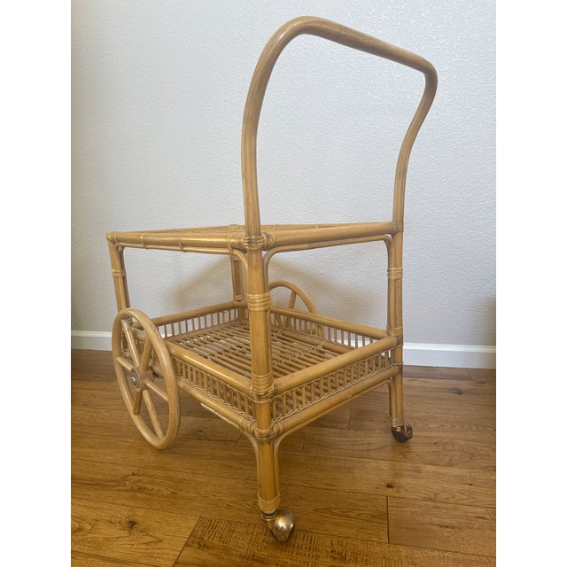 Elevate your space with this authentic vintage rattan bar cart from the 1970s, a true mid-century modern gem. With its...