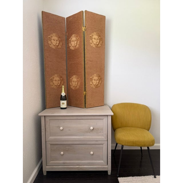 A wonderfully decorative three-panel folding screen with two distinct upholstered faces. One side features repeated...
