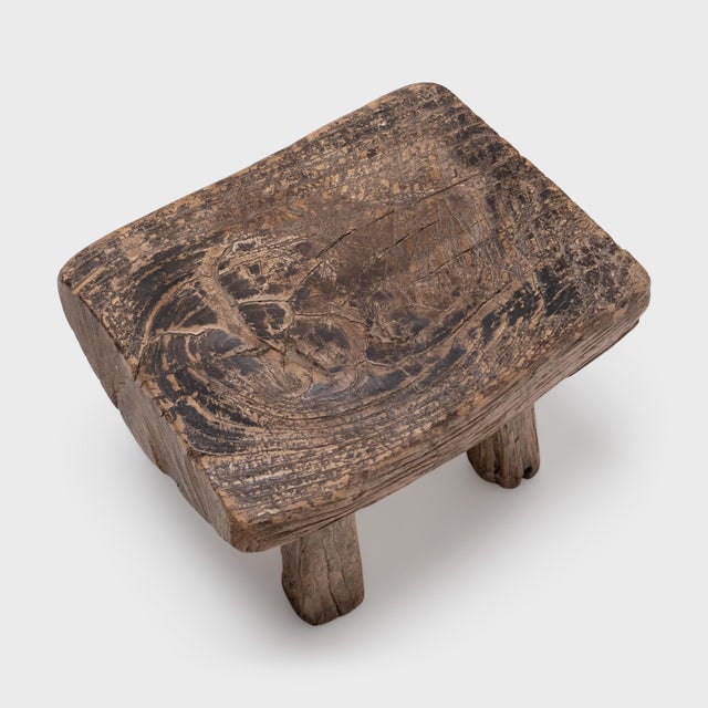 This petite Chinese stool was hand-crafted in the early 19th century, cobbled together from spare materials for use...