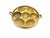 A beautifully timeworn primitive brass food mold featuring a charming assortment of oval and floral cavity forms, likely...