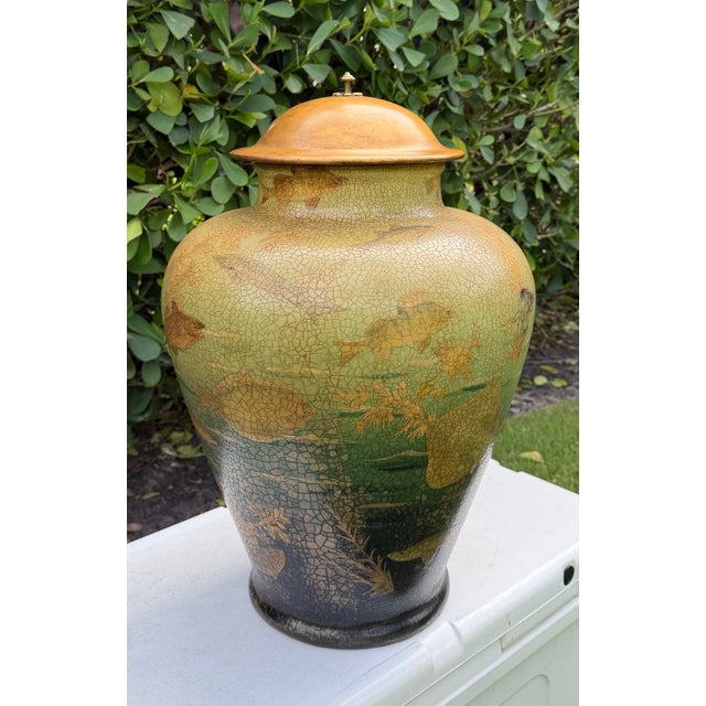 Oversized lidded jar featuring a richly detailed underwater scene with fish, aquatic plants, and layered blue-green tones....