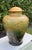 Oversized lidded jar featuring a richly detailed underwater scene with fish, aquatic plants, and layered blue-green tones....